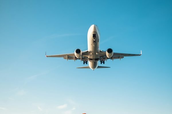 woman filming plane landing on phone